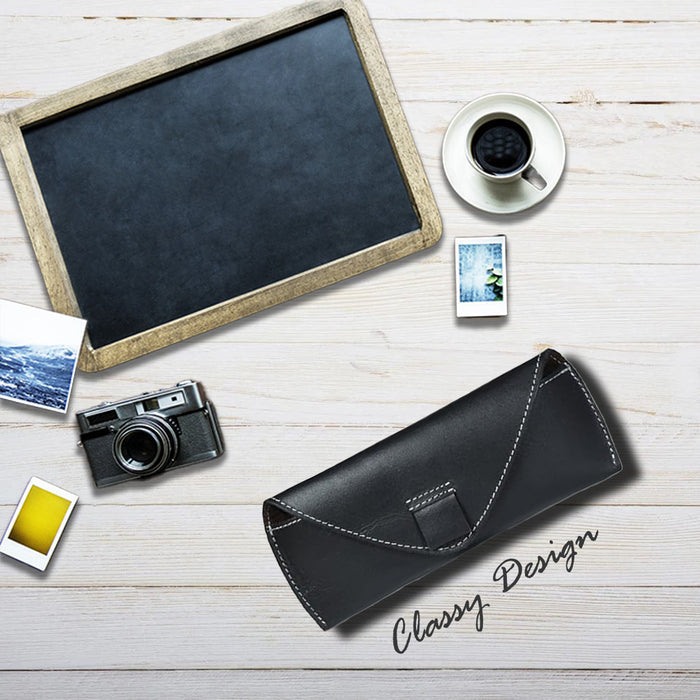 Black leather wallet, camera, and coffee on a wooden surface with 'Classy Design' text.
