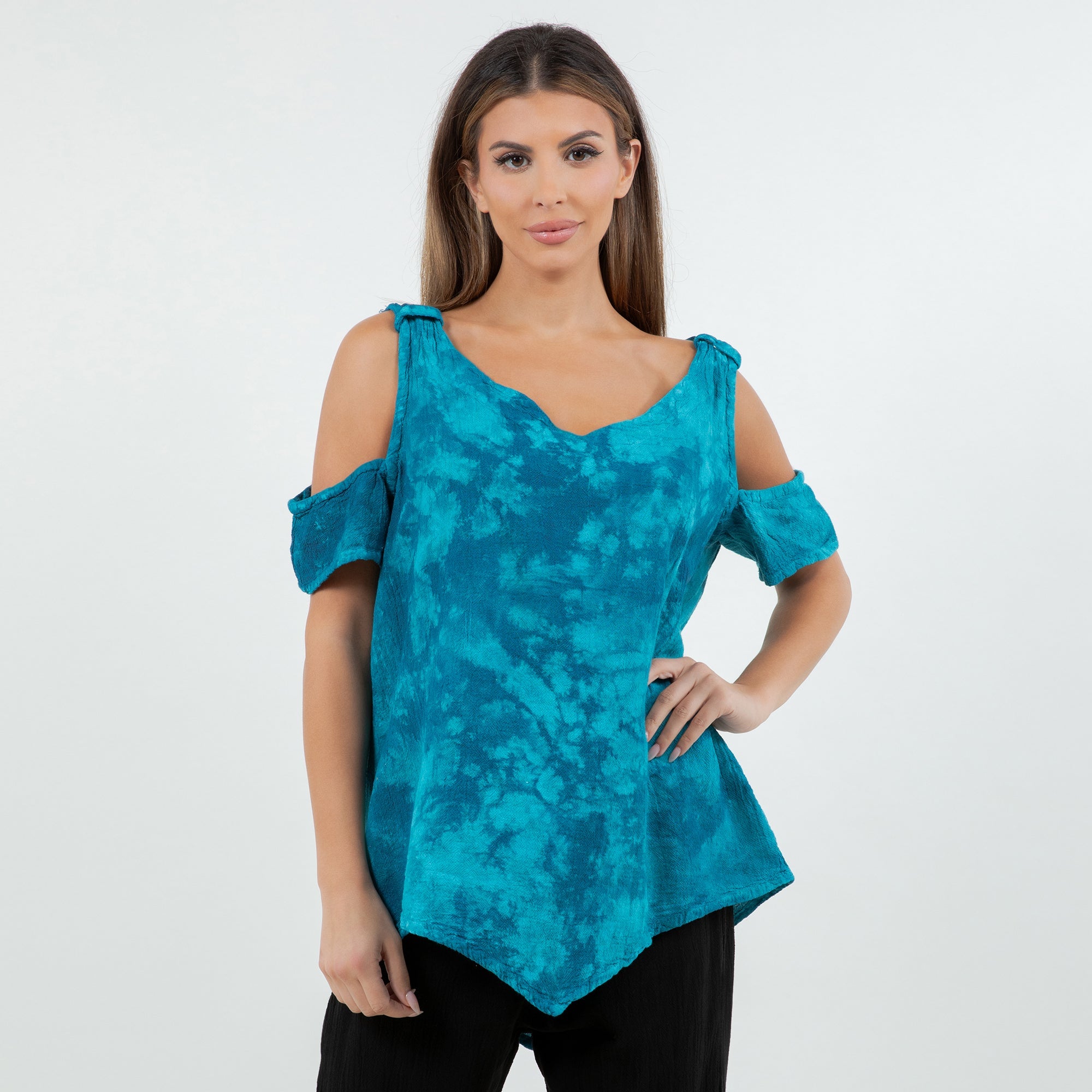 Woman wearing a blue tie-dye top with cold shoulder design on a white background