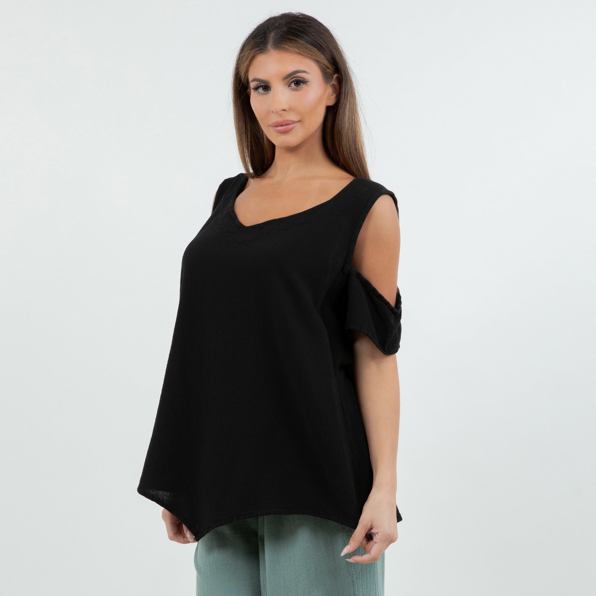 Woman wearing a black top with short sleeves on a white background