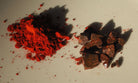 Red powder and chocolate pieces on a light surface