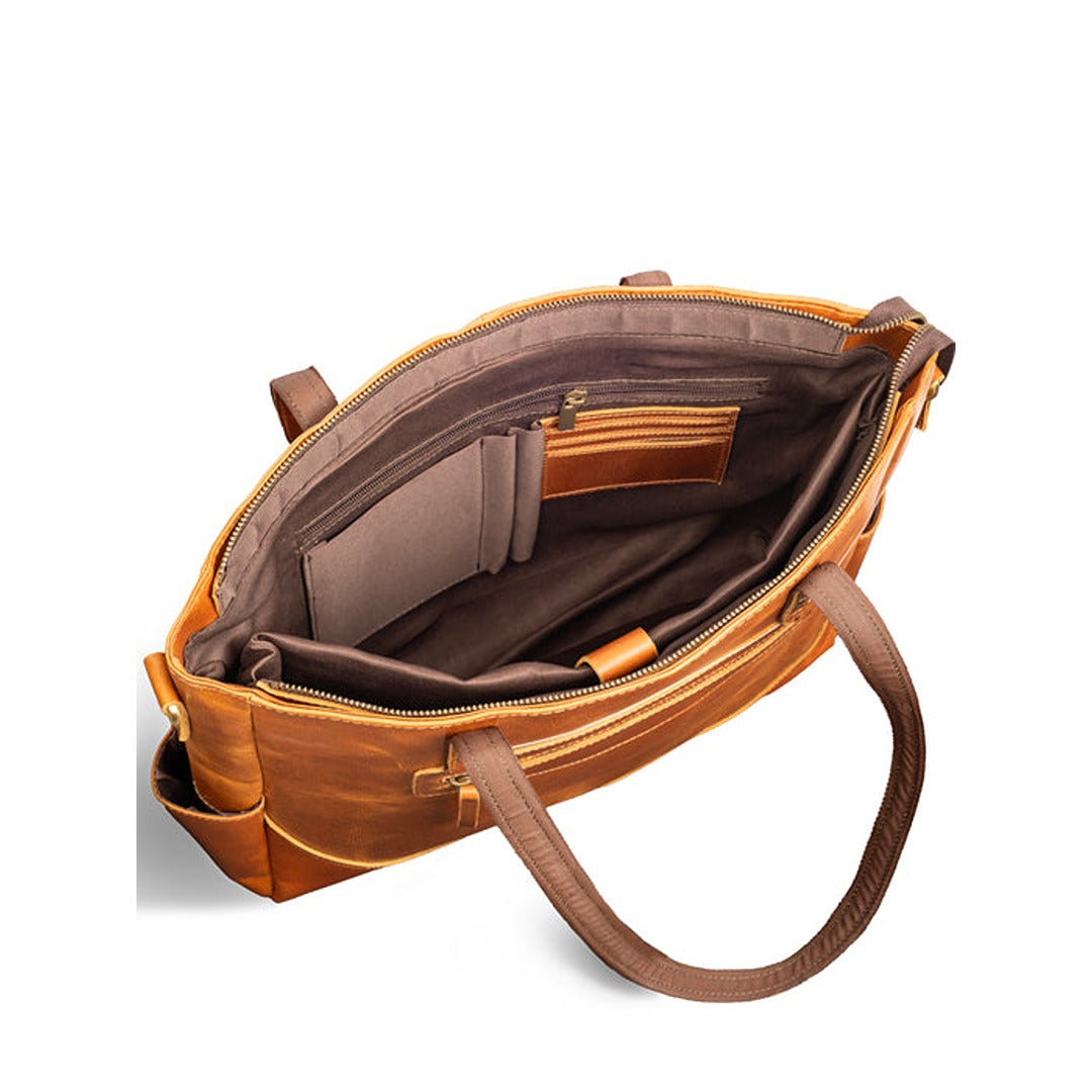 Brown leather handbag with open interior on a white background