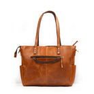 Brown leather tote bag on a white background