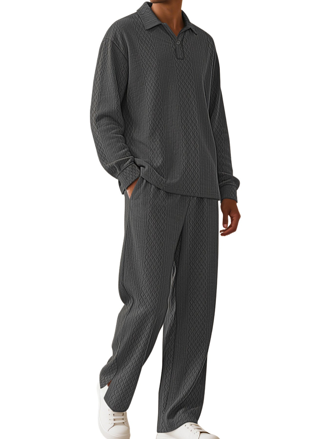 A man wearing a dark gray textured two-piece loungewear set consisting of a long-sleeve polo shirt and matching pants, paired with white sneakers, against a plain white background.