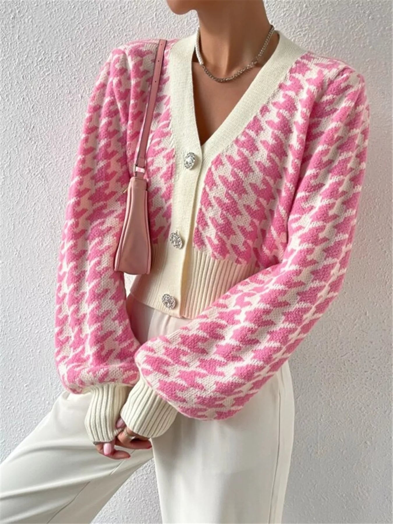 Upgrade your wardrobe with the Houndstooth V-Neck Button Up Cardigan, which pairs a classic pattern with a sleek, tailored silhouette. Designed for flexibility, this cardigan presents a lasting houndstooth print and a flattering V-neckline that layers comfortably over shirts or casual tops. The button-up front offers customizable fit and style, making it an elegant option for both business and casual wear. Combining resilience with sophistication, this garment harmonizes timeless tradition with contemporary