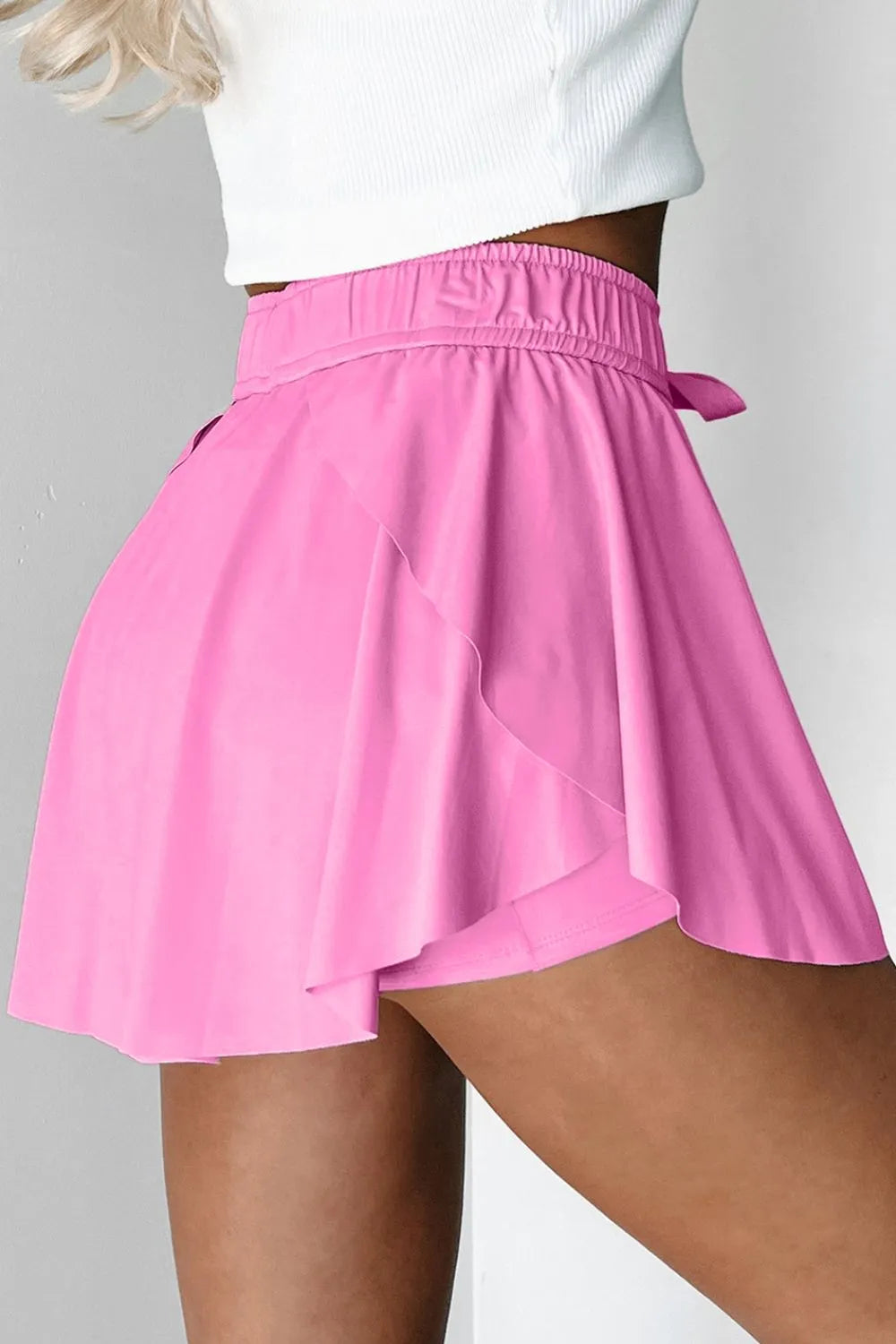 Pink skirt worn by a person on a gray background