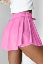 Pink skirt worn by a person on a gray background