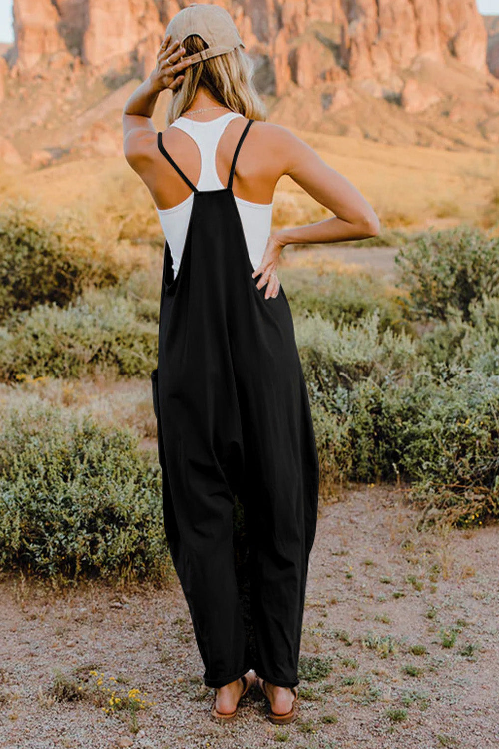 Elevate your style game with our Double Take Jumpsuit. This effortlessly chic and functional piece features a flattering V-neck, comfortable sleeveless design, and convenient pockets. Perfect for any occasion, it will keep you looking and feeling your best. Add this must-have to your wardrobe today.