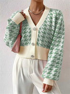 The Houndstooth V-Neck Button Up Cardigan offers a classic pattern with a tailored fit. Its V-neck design layers well over shirts, and the button-up front ensures adjustable comfort. This durable cardigan is perfect for both work and casual wear.