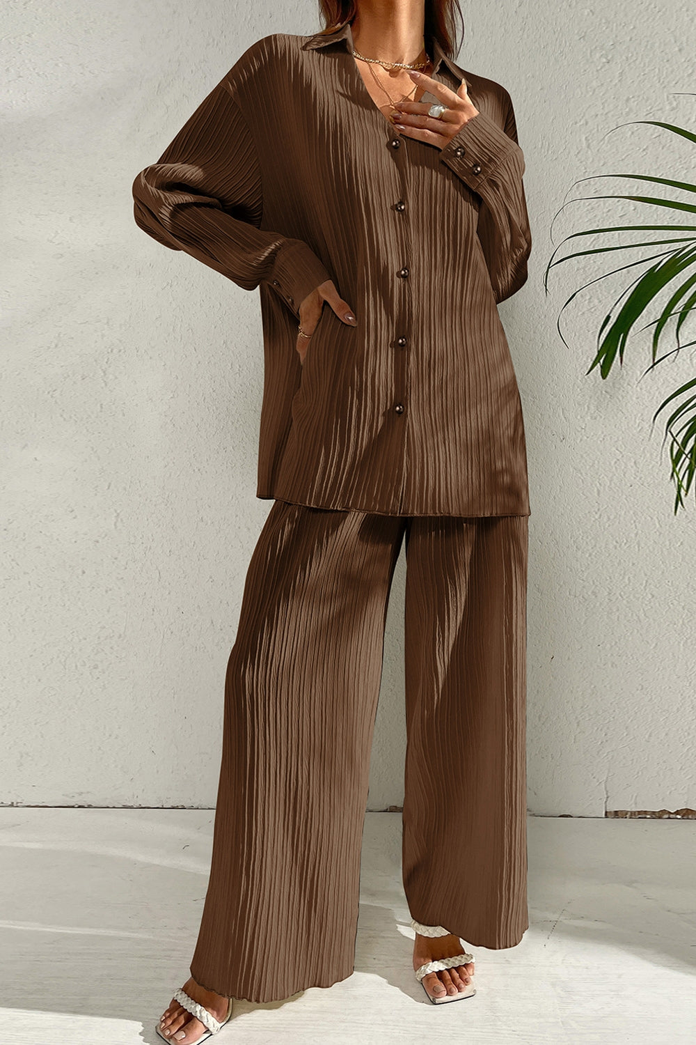 A woman wearing the Capri Collared Button-Down Pant Set in Brown, shown in a relaxed long-sleeve silhouette with a clean tailored collar and fluid wide-leg pants.