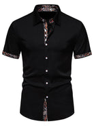 Black short-sleeve shirt with floral patterns on collar and cuffs against a white background