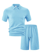 Men's luxury two-piece travel resort outfit featuring a short-sleeve textured top and matching shorts in sky blue.