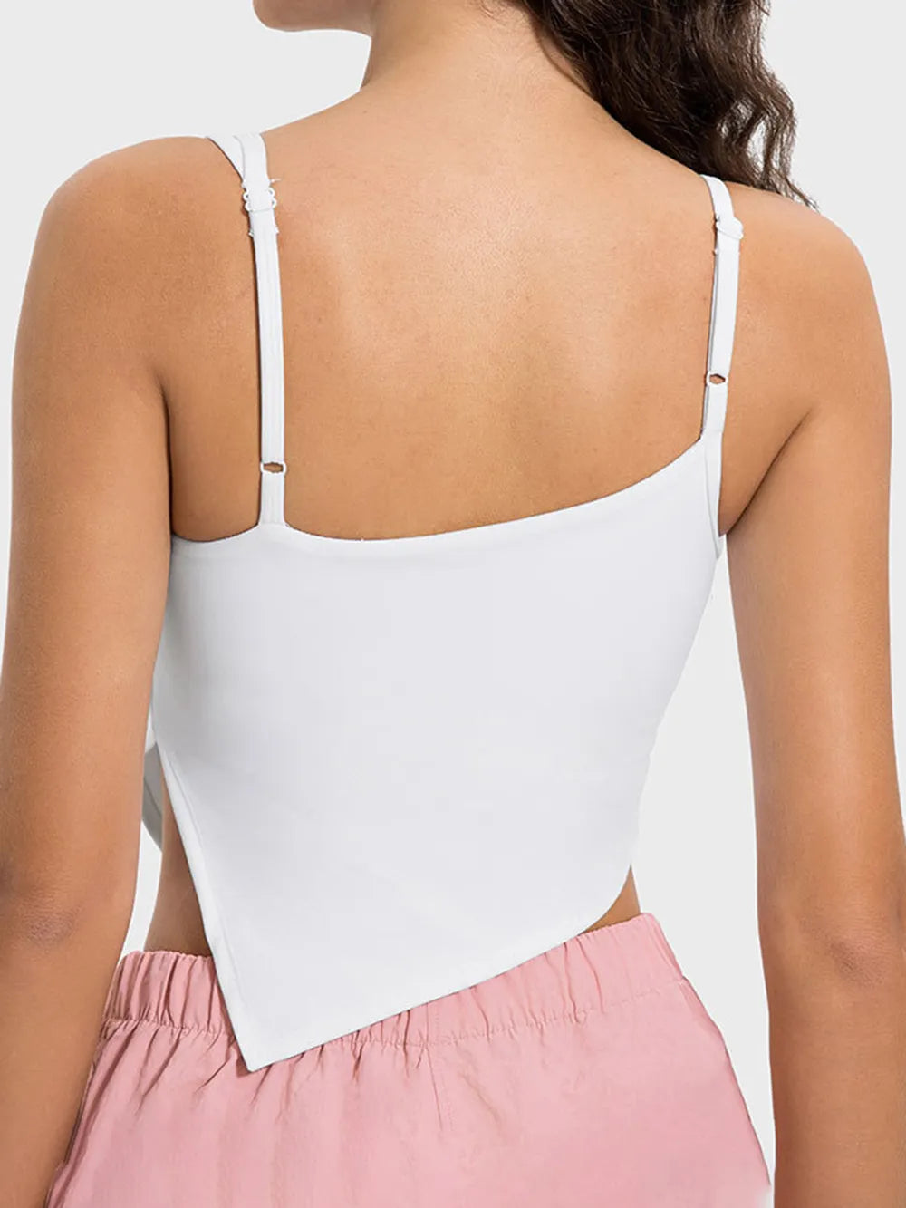 White tank top worn by a person on a white background