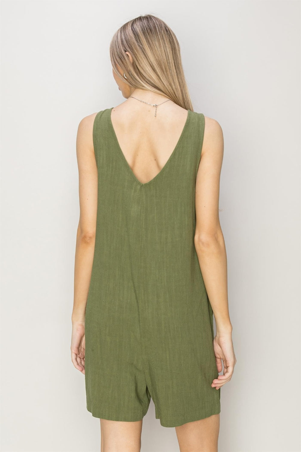This V-Neck Sleeveless Romper combines comfort and style with its breathable 80% rayon and 20% linen fabric. Featuring a deep V-neck and relaxed bodice, it flatters every figure while the breezy shorts keep you cool. Equipped with handy pockets, it offers practicality without compromising on fashion. Pair it with sandals and a crossbody bag for an effortlessly chic and timeless look perfect for any casual outing.