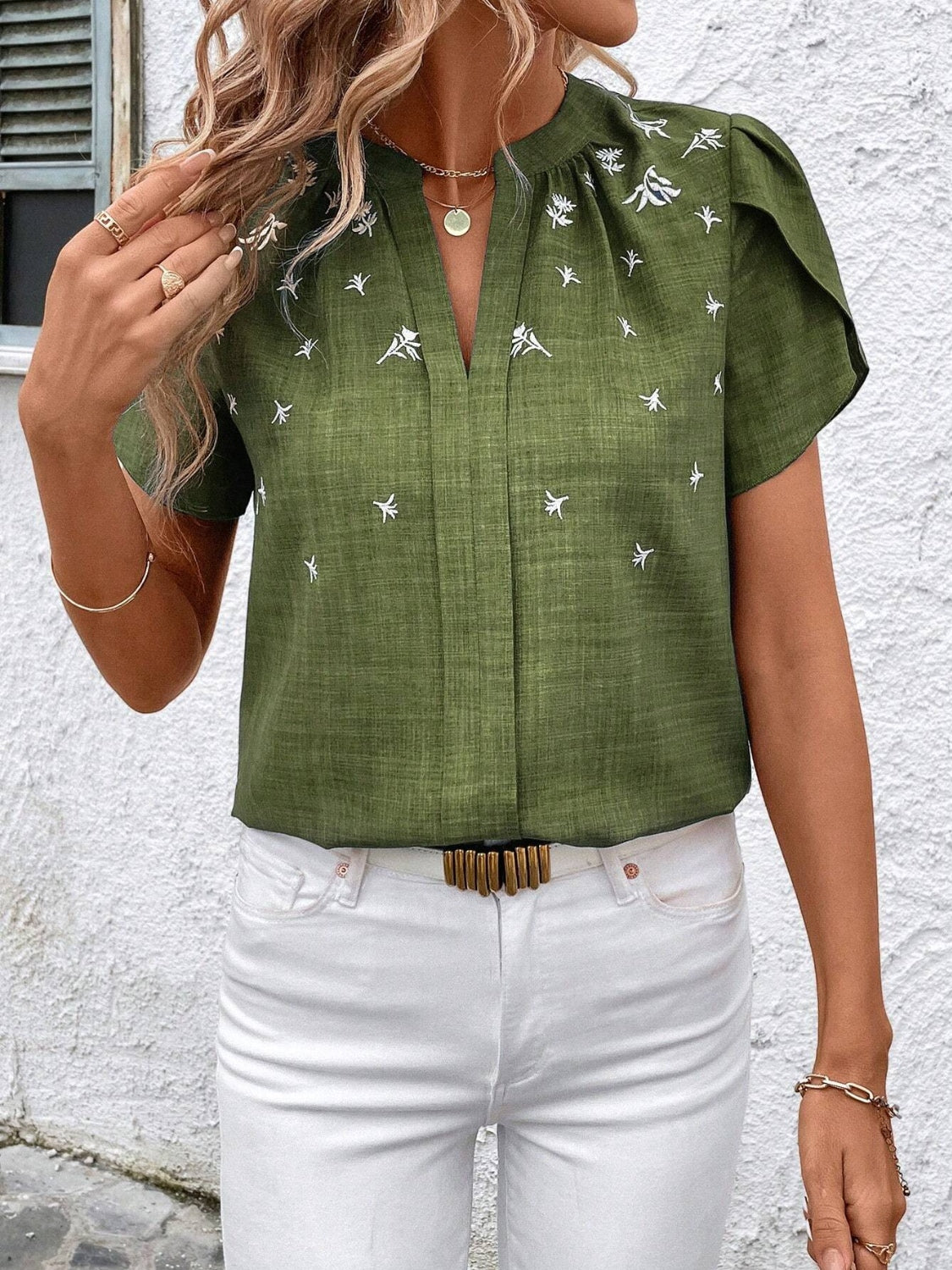 This Floral Notched Short Sleeve Blouse features a stylish notched neckline and a delicate floral print. Made from breathable fabric, it offers comfort for all-day wear and works well for both work and casual occasions.
