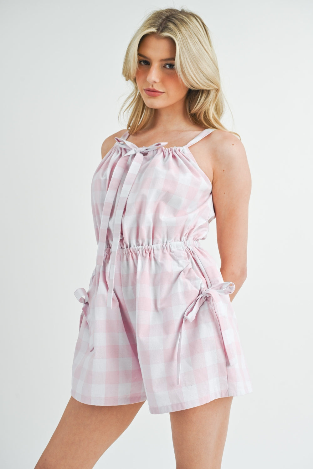 Make a statement with the effortlessly chic and versatile plaid sleeveless button-down romper. The classic plaid pattern adds a touch of preppy charm to the trendy romper silhouette. Easy to wear and style, it offers comfort and ease of movement while still making a fashionable statement. Perfect for any casual outing or picnic, this romper will quickly become a go-to for your everyday wardrobe. Upgrade your style with the perfect combination of plaid print and romper design.