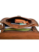 Brown leather bag with compartments and items inside on a white background