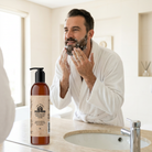 Man applying beard wash at a bright bathroom sink
