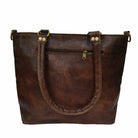 Brown leather tote bag with gold hardware on a white background