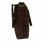 Brown leather bag with gold accents on a white background