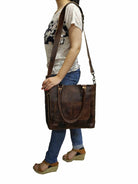 Person wearing a brown leather shoulder bag on a white background