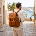 Traveler wearing the Vortex backpack in a coastal town